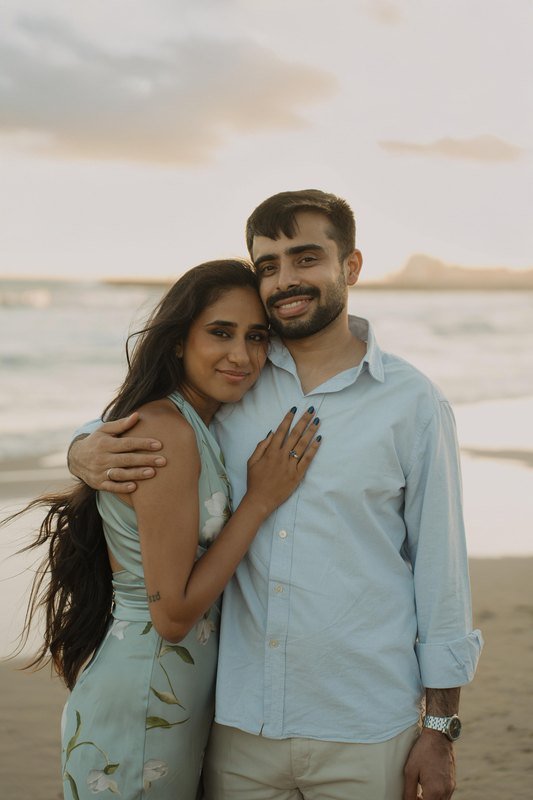 Sindhu and Amish smiling on the beach