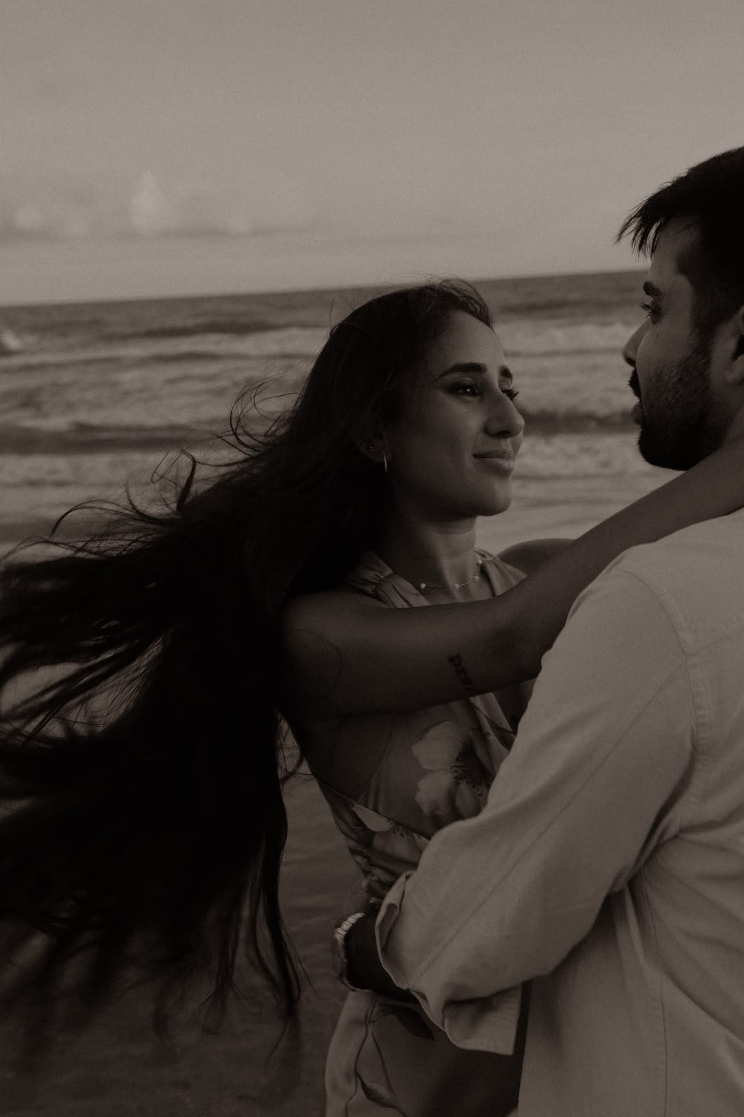 Sindhu smiling in Amish's arms, hair in the wind